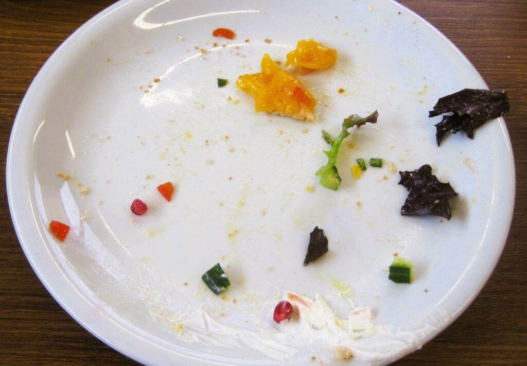 The plate shows leftover food scraps.