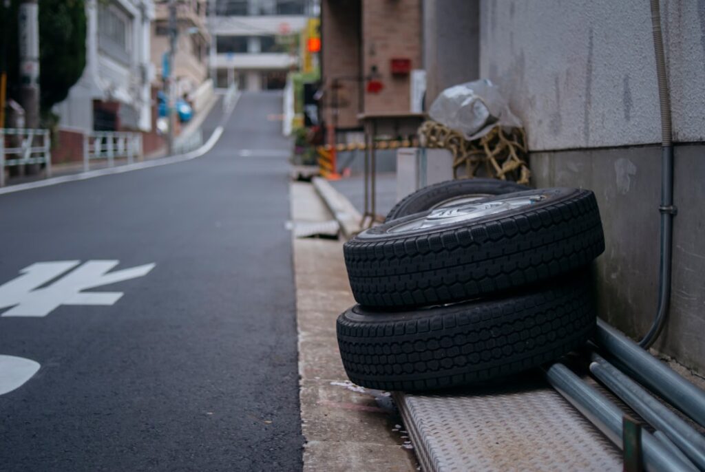 black car tire on road during daytime