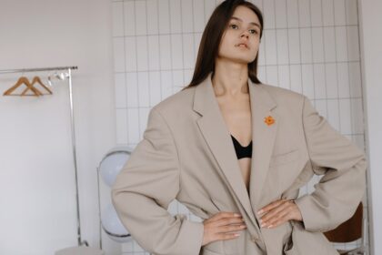 A woman poses in an oversized blazer.