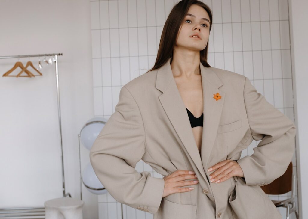 A woman poses in an oversized blazer.