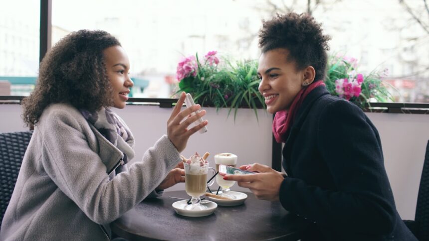 Two women talking at a cafe with drinks