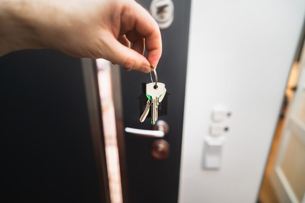 A person is holding a key to a door