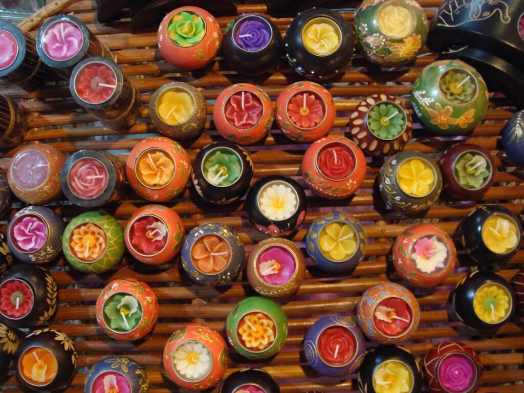 a bunch of colorful candles sitting on top of a wooden table