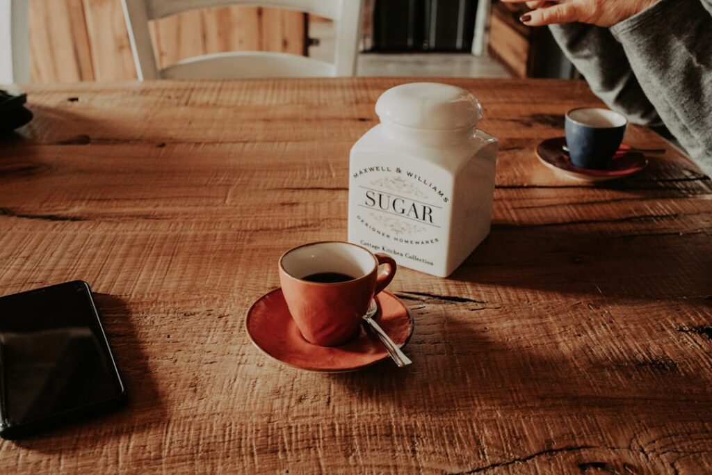 a coffee cup and a salt shaker on a table