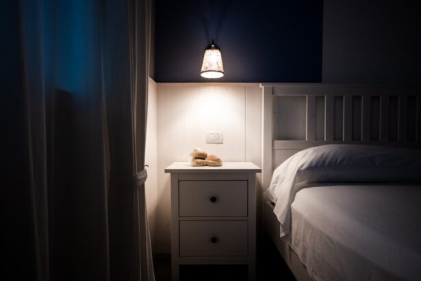 A bedside lamp illuminates a nightstand next to a bed.