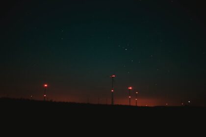 the night sky is lit up by street lights