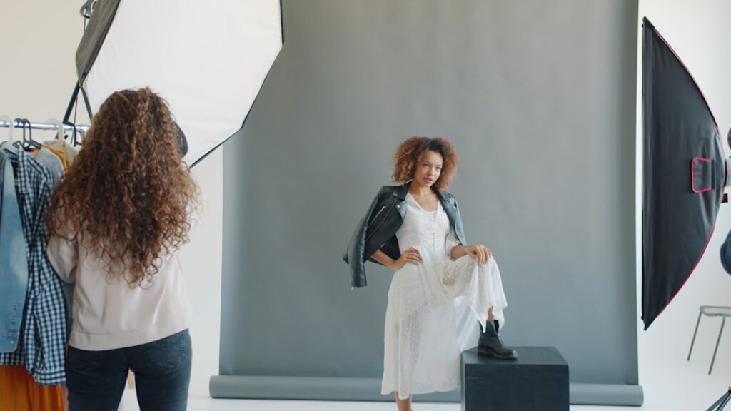 Model posing for photographer in studio setting