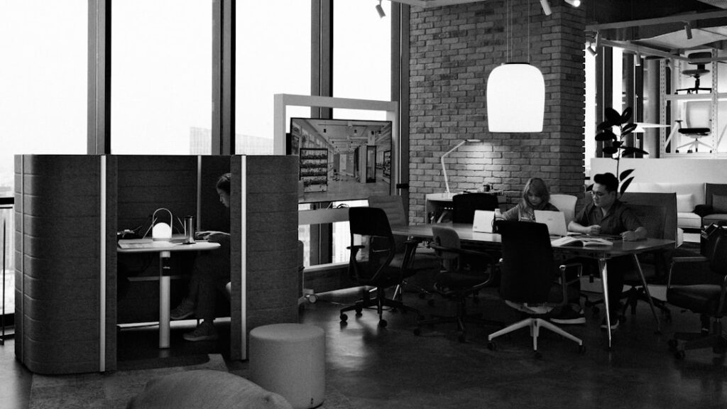Modern office space with people working at desks.