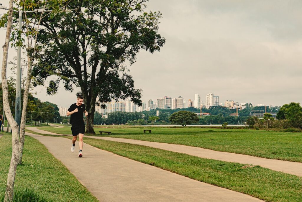 a man running down a path in a park