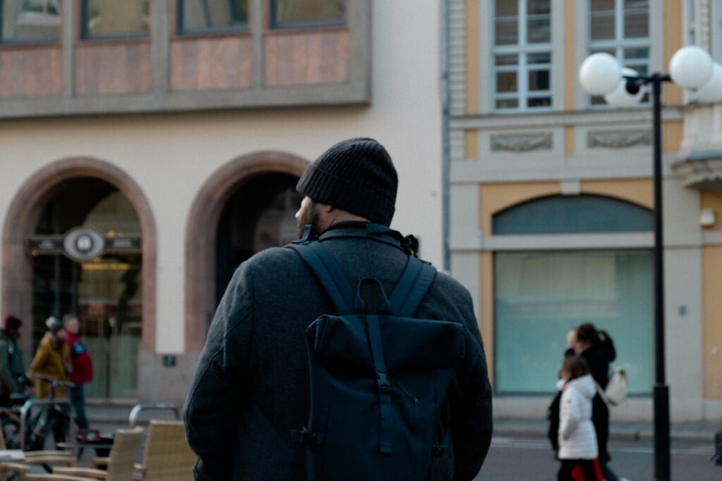 Person wearing a backpack walking on a city street.